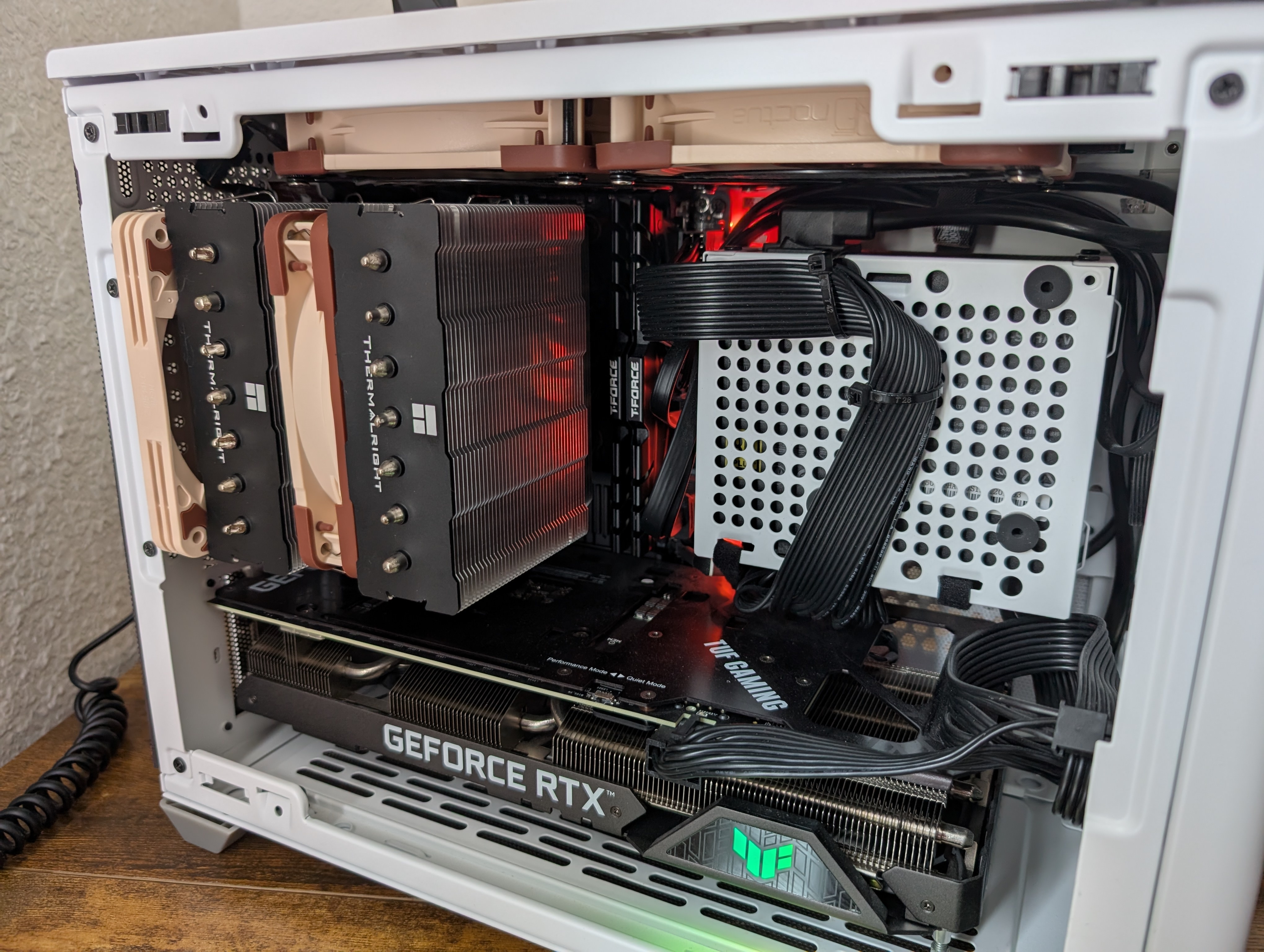 Photo of a white NR200 case with a Thermalright Phantom Spirit 120 and 3060ti GPU. The CPU cooler uses a 120mm fan in the middle and a 15mm fan at the back. 